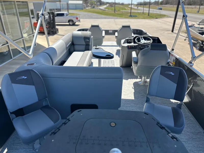 Slide: The Image of 2025 Bennington 22 SF pontoon boat interior with seating and steering console. - 4