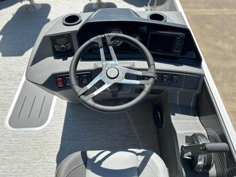 Slide: The Image of 2025 Bennington 22 SF boat dashboard with steering wheel and controls. - 5