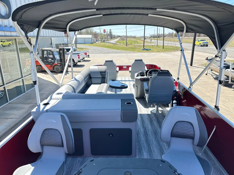 Slide: The Image of 2025 Bennington 23 SF pontoon boat interior with seating and helm under canopy. - 4