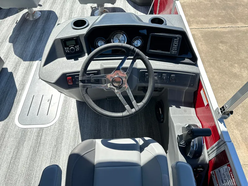 Slide: The Image of 2025 Bennington 23 SF boat dashboard with steering wheel and control panel. - 5