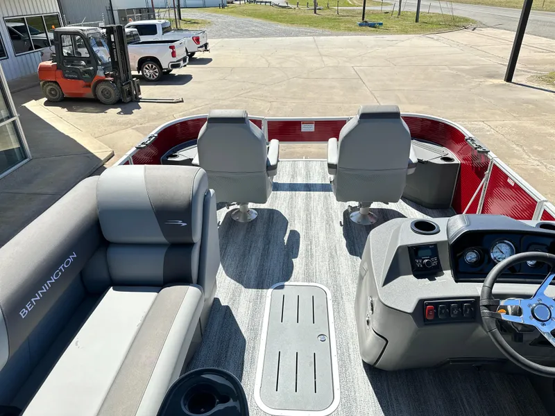 Slide: The Image of 2025 Bennington 23 SF boat interior with gray seating and steering console. - 6
