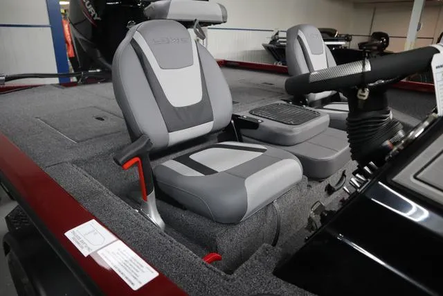 Slide: The Image of 2025 Lowe Stinger 175 C boat interior with gray seats and steering console. - 3