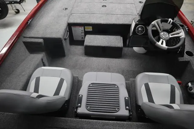 Slide: The Image of 2025 Lowe Stinger 175 C boat interior with gray seating and steering console. - 4