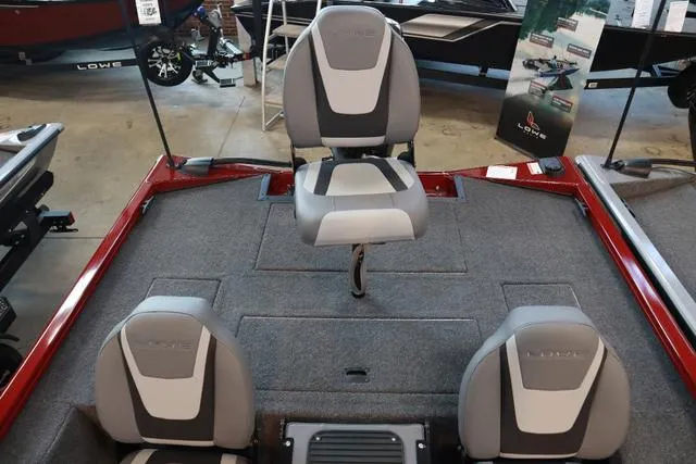 Slide: The Image of 2025 Lowe Stinger 175 C boat interior with three gray seats and carpeted deck. - 5