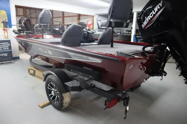 Slide: The Image of 2025 Lowe Stinger 175 C boat with Mercury engine in showroom. - 6