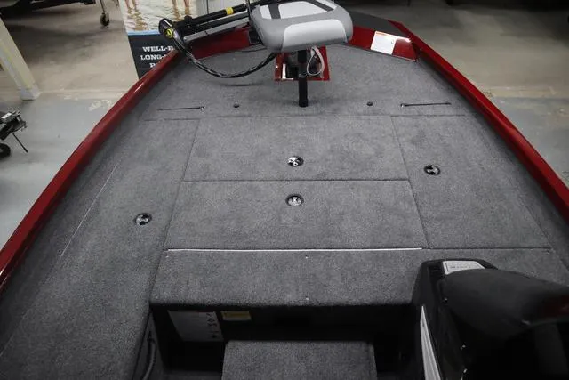 Slide: The Image of 2025 Lowe Stinger 175 C boat interior with carpeted deck and swivel seat. - 7