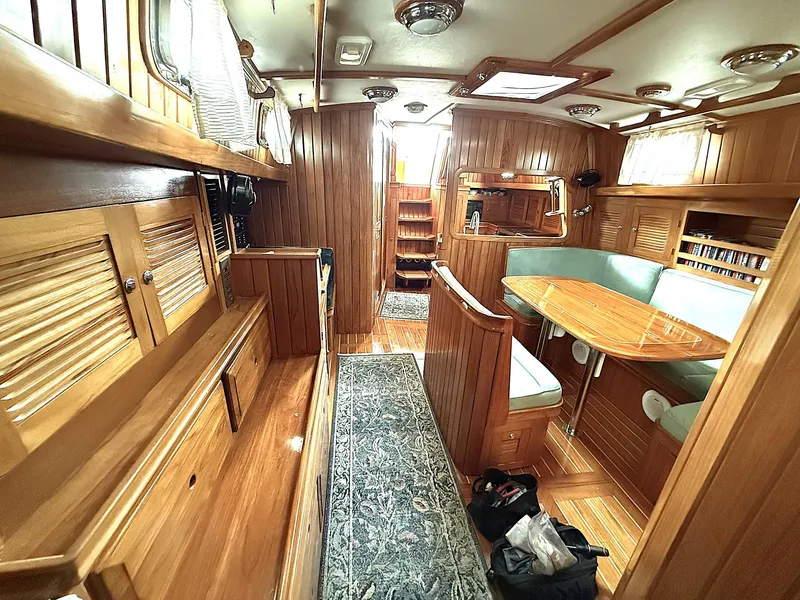 Slide: The Image of Luxurious 2000 Cabo Rico Pearl Edition yacht interior with wood finish and cozy seating area. - 15