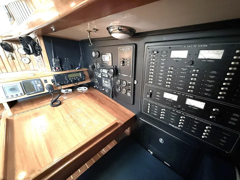 Slide: The Image of Navigation station of 2000 Cabo Rico Pearl Edition yacht with control panels and communication equipment. - 17