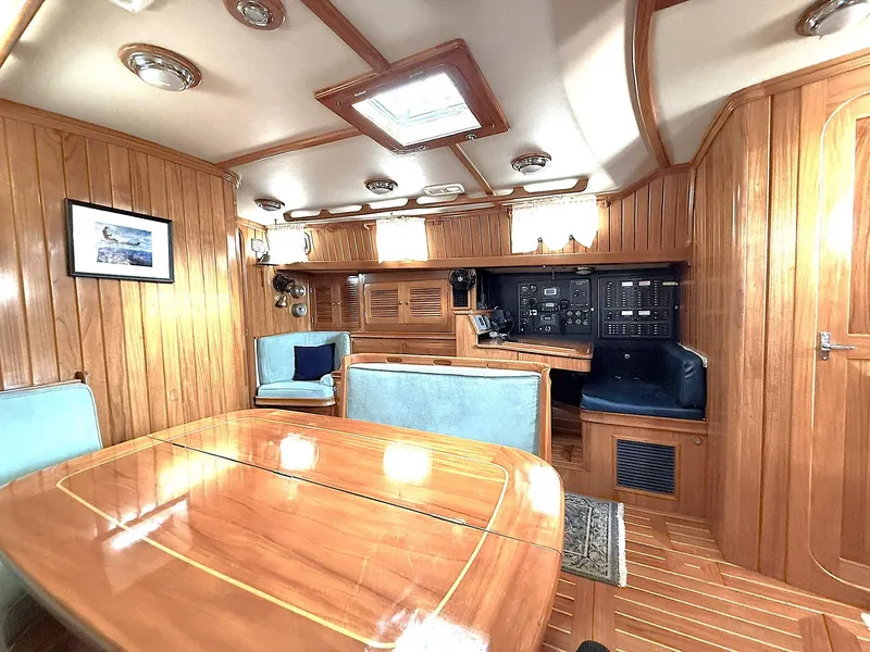 Slide: The Image of Luxurious 2000 Cabo Rico Pearl Edition yacht interior with wood paneling and elegant seating. - 18