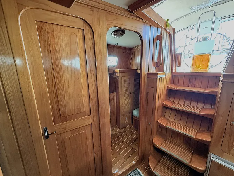 Slide: The Image of Interior of 2000 Cabo Rico Pearl Edition yacht with wooden finishes and staircase. - 19