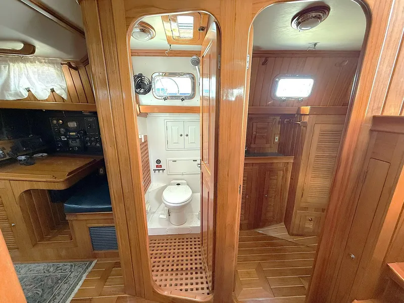 Slide: The Image of Interior of 2000 Cabo Rico Pearl Edition yacht, featuring wooden cabinetry and compact bathroom. - 20