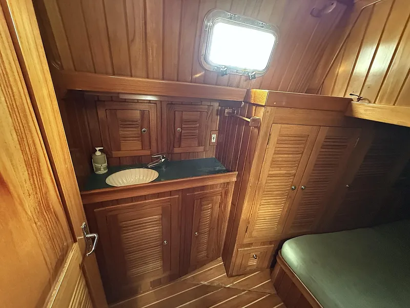 Slide: The Image of Interior of 2000 Cabo Rico Pearl Edition yacht with wooden cabinetry and cozy sleeping area. - 21