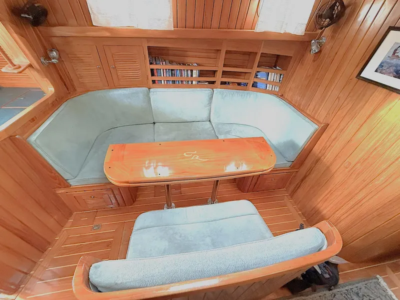Slide: The Image of Cabo Rico 2000 Pearl Edition yacht interior with wooden finish and cushioned seating. - 23