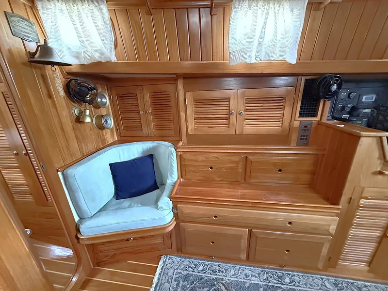 Slide: The Image of Interior of 2000 Cabo Rico Pearl Edition yacht with wooden cabinetry and cushioned seating. - 24