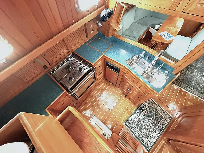 Slide: The Image of Luxurious Cabo Rico Pearl Edition 2000 yacht interior with wood finish and modern kitchen amenities. - 3