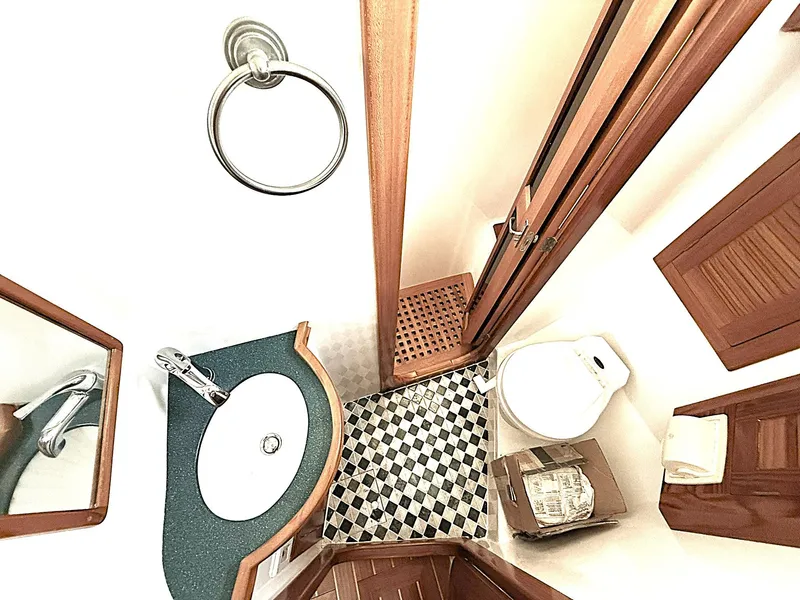 Slide: The Image of Luxurious bathroom in 2000 Cabo Rico Pearl Edition yacht, featuring elegant wood accents and modern fixtures. - 4