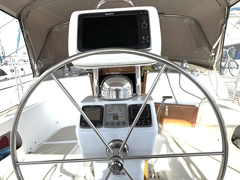 Slide: The Image of Steering wheel and navigation equipment on 2000 Cabo Rico Pearl Edition yacht. - 44