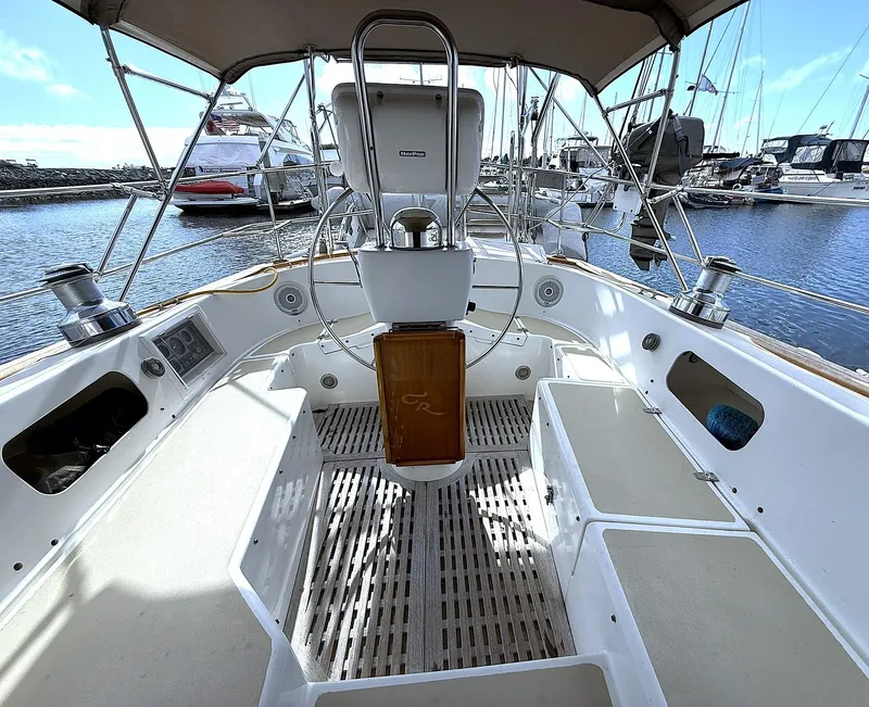 Slide: The Image of Cabo Rico Pearl Edition Anniversary Special 2000 sailboat cockpit with steering wheel and marina view. - 5