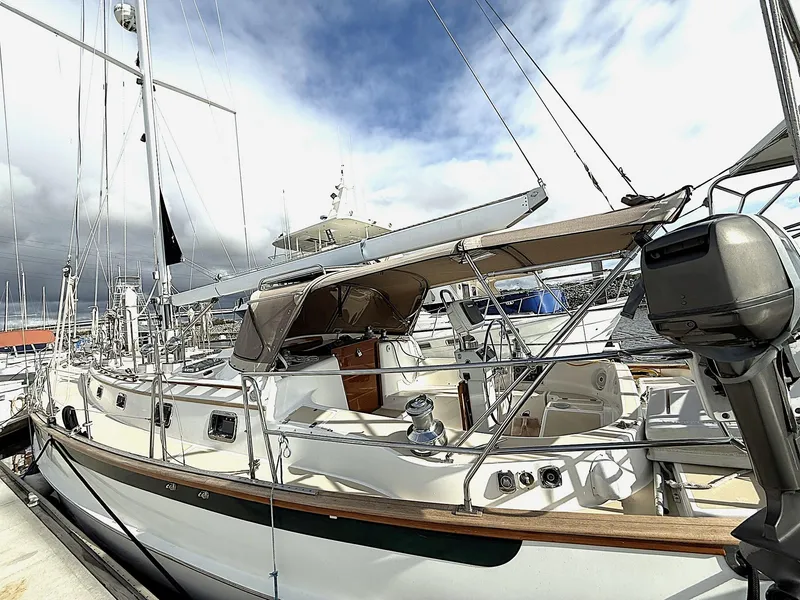 Slide: The Image of Cabo Rico Pearl Edition Anniversary Special yacht, 2000 model, docked at marina under cloudy sky. - 7