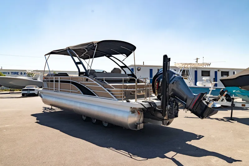 Slide: The Image of 2022 Bennington LX 24 Swingback pontoon boat with canopy and outboard motor. - 12