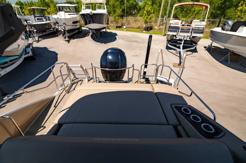 Slide: The Image of 2022 Bennington LX 24 Swingback boat with sleek design and modern features, docked outdoors. - 16