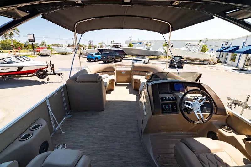 Slide: The Image of 2022 Bennington LX 24 Swingback pontoon boat interior with helm and seating area. - 18