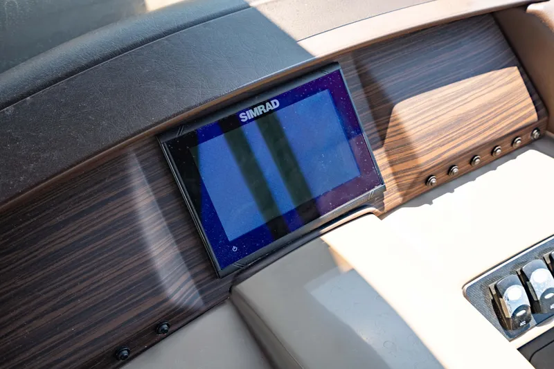Slide: The Image of Dashboard of 2022 Bennington LX 24 Swingback with Simrad display and wood finish. - 21