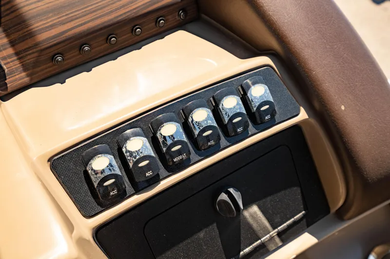 Slide: The Image of Control panel of 2022 Bennington LX 24 Swingback boat with switches and knobs. - 22