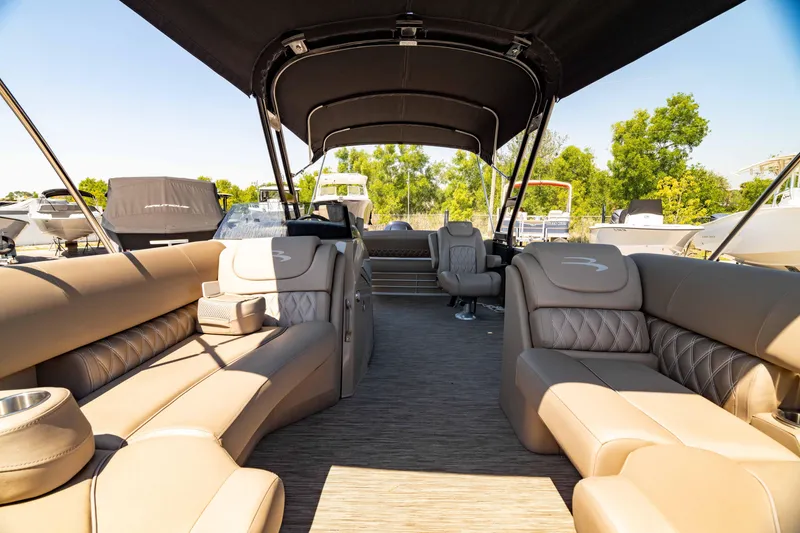Slide: The Image of 2022 Bennington LX 24 Swingback interior with luxurious seating and canopy, docked outdoors. - 40