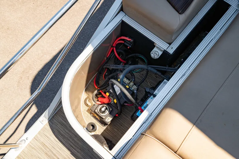 Slide: The Image of 2022 Bennington LX 24 Swingback boat battery compartment with wiring and connections. - 44