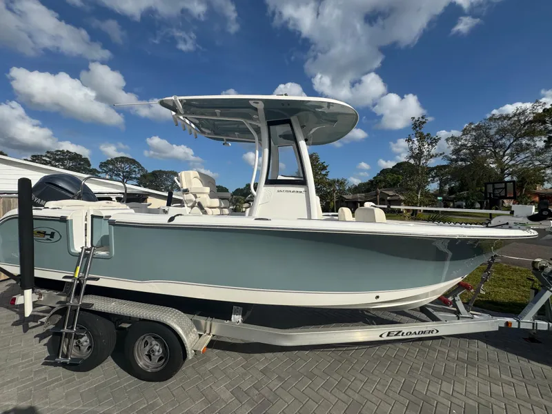 Slide: The Image of 2019 Sea Hunt 235 SE boat on trailer under blue sky. - 12