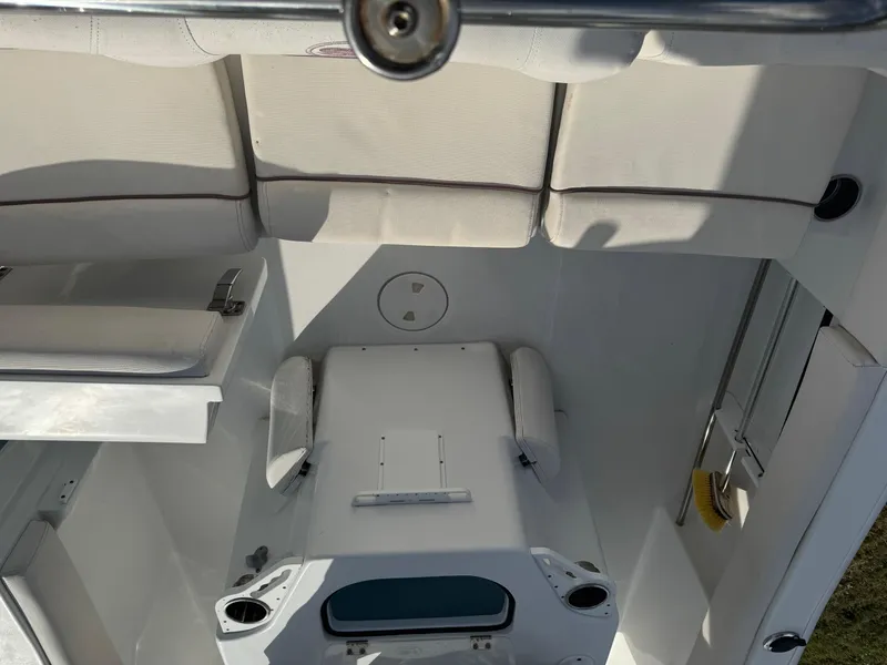 Slide: The Image of 2019 Sea Hunt 235 SE boat interior with cushioned seating and storage compartments. - 25