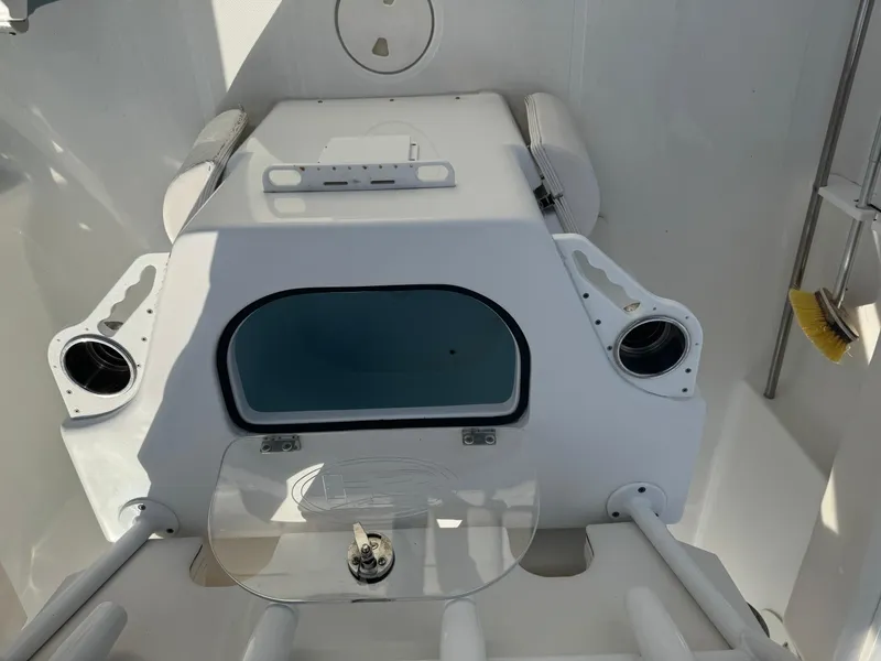 Slide: The Image of 2019 Sea Hunt 235 SE boat interior with storage compartment and rod holders. - 28