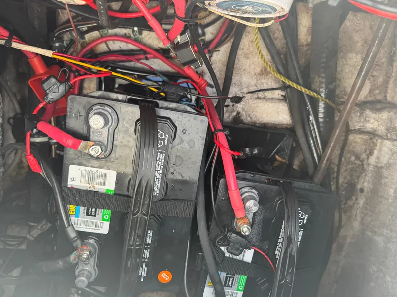 Slide: The Image of Battery compartment of a 2019 Sea Hunt 235 SE boat with wiring connections. - 29