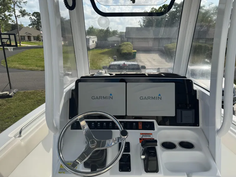 Slide: The Image of 2019 Sea Hunt 235 SE boat dashboard with Garmin navigation displays. - 32
