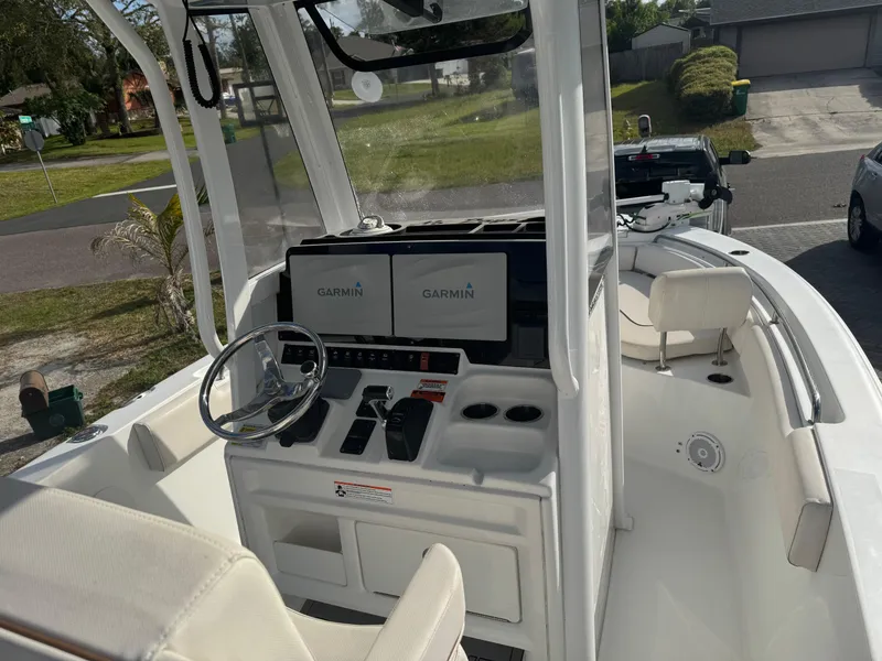 Slide: The Image of 2019 Sea Hunt 235 SE boat interior with Garmin navigation system and steering console. - 35