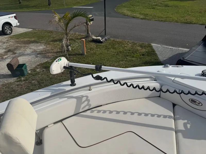 Slide: The Image of 2019 Sea Hunt 235 SE boat with trolling motor on deck, parked near a road. - 38