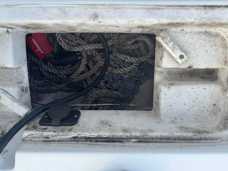 Slide: The Image of Storage compartment with ropes and cables on a 2019 Sea Hunt 235 SE boat. - 42