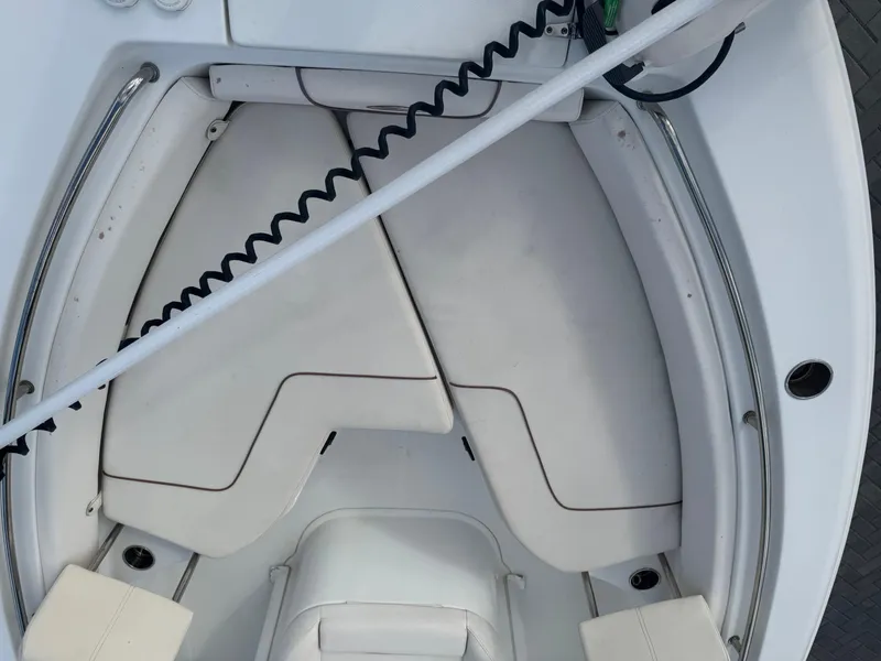 Slide: The Image of 2019 Sea Hunt 235 SE boat interior with cushioned seating and storage compartments. - 44