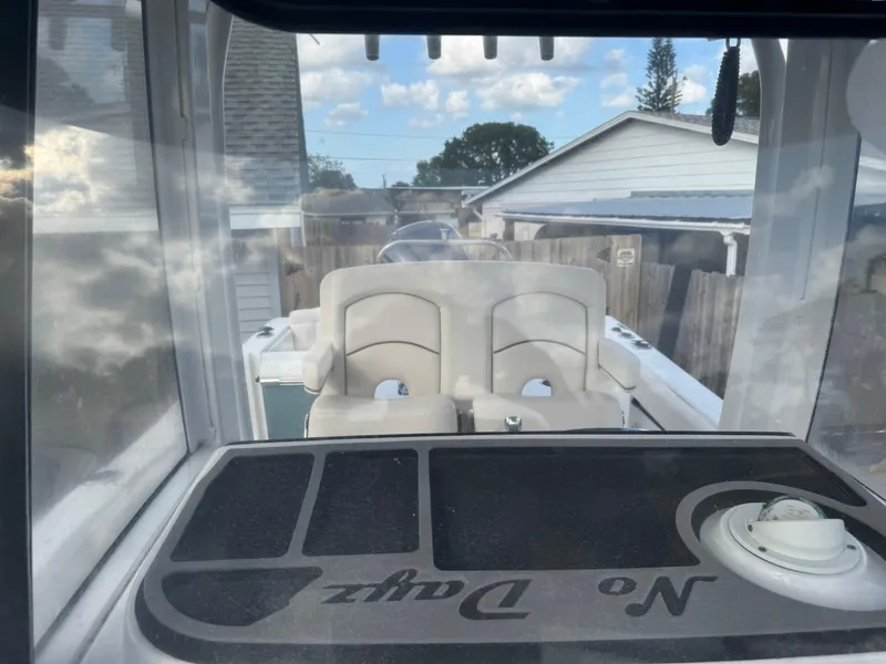 Slide: The Image of 2019 Sea Hunt 235 SE boat interior with seating and dashboard view. - 46