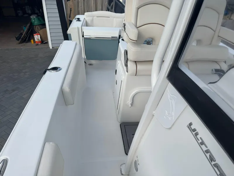 Slide: The Image of 2019 Sea Hunt 235 SE boat interior with white seating and storage compartments. - 48