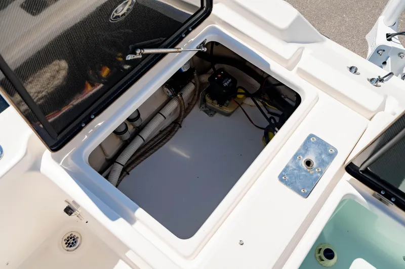 Slide: The Image of Open storage compartment on 2015 Edgewater 240 Inshore boat, showing internal wiring and components. - 12