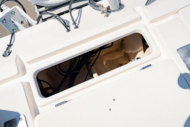 Slide: The Image of Open storage compartment on 2015 Edgewater 240 Inshore boat deck. - 13
