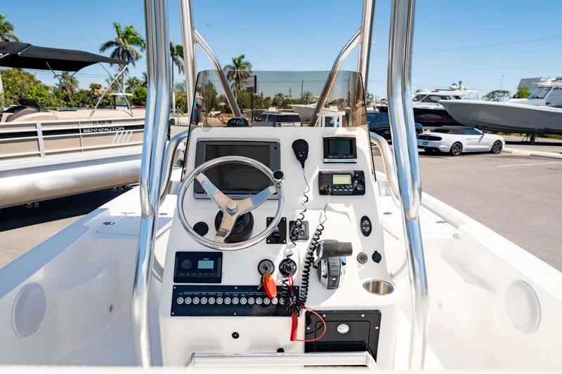 Slide: The Image of 2015 Edgewater 240 Inshore boat dashboard with steering wheel and controls. - 15