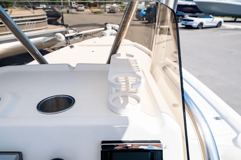 Slide: The Image of Edgewater 240 Inshore 2015 boat dashboard with cup holder and windshield. - 18
