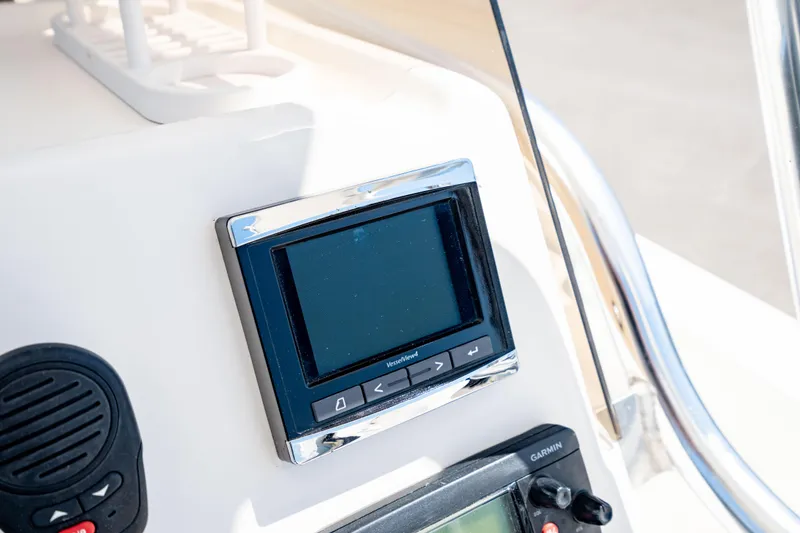 Slide: The Image of Control panel on 2015 Edgewater 240 Inshore boat dashboard with electronic display. - 19