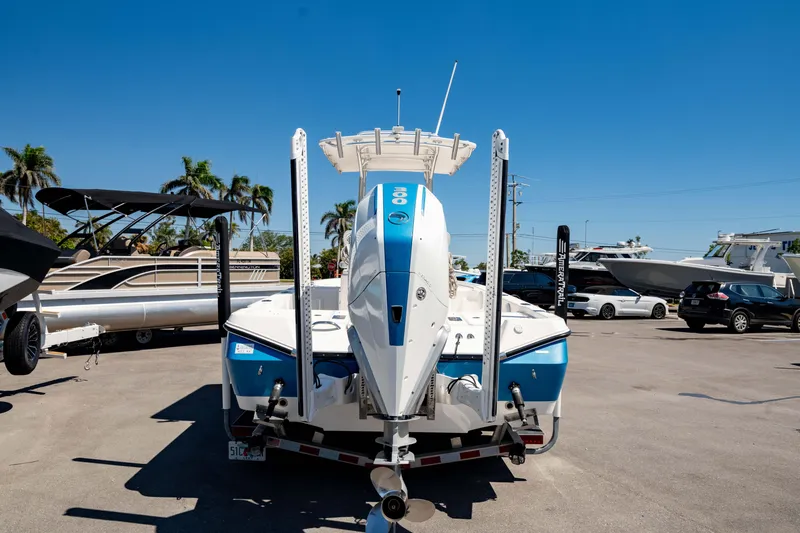 Slide: The Image of 2015 Edgewater 240 Inshore boat on trailer in sunny marina setting. - 2