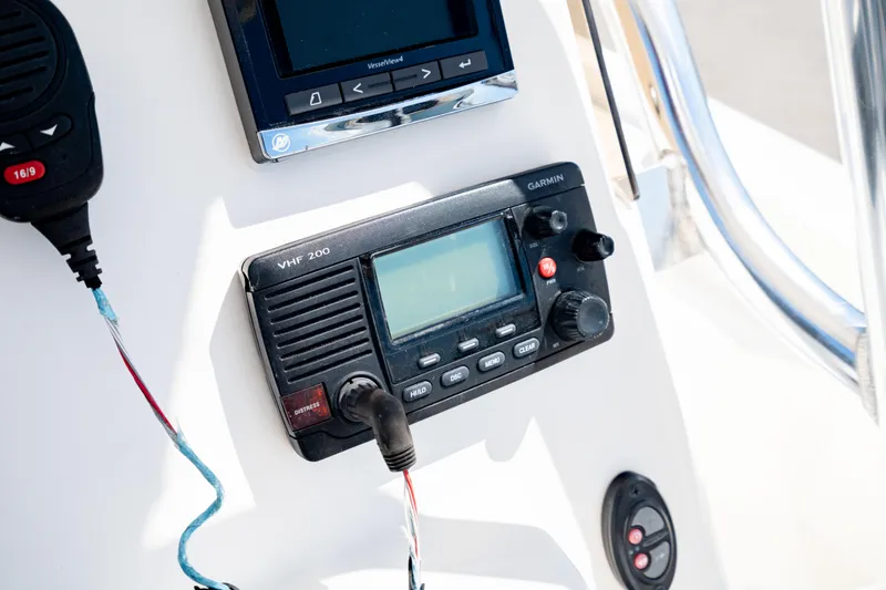 Slide: The Image of Control panel of a 2015 Edgewater 240 Inshore boat with Garmin VHF 100 radio. - 20