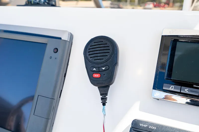 Slide: The Image of Control panel of 2015 Edgewater 240 Inshore boat with VHF radio and display screens. - 21