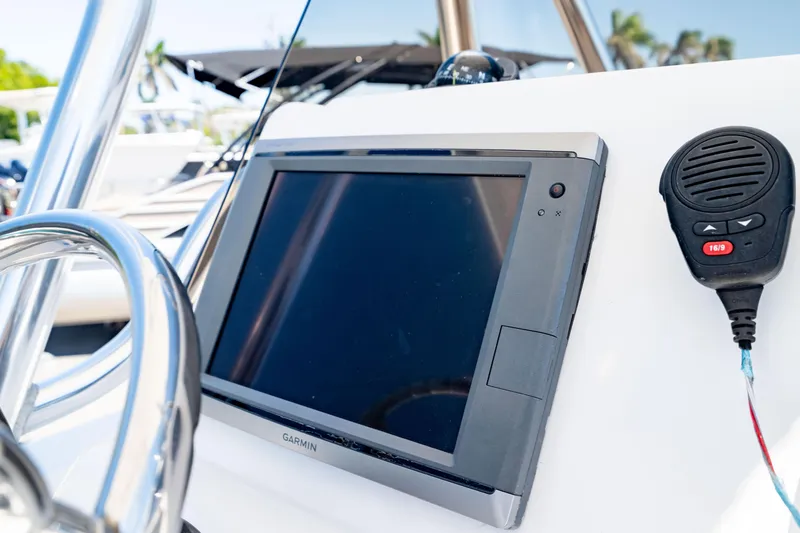 Slide: The Image of Edgewater 240 Inshore 2015 boat console with Garmin display and radio microphone. - 22